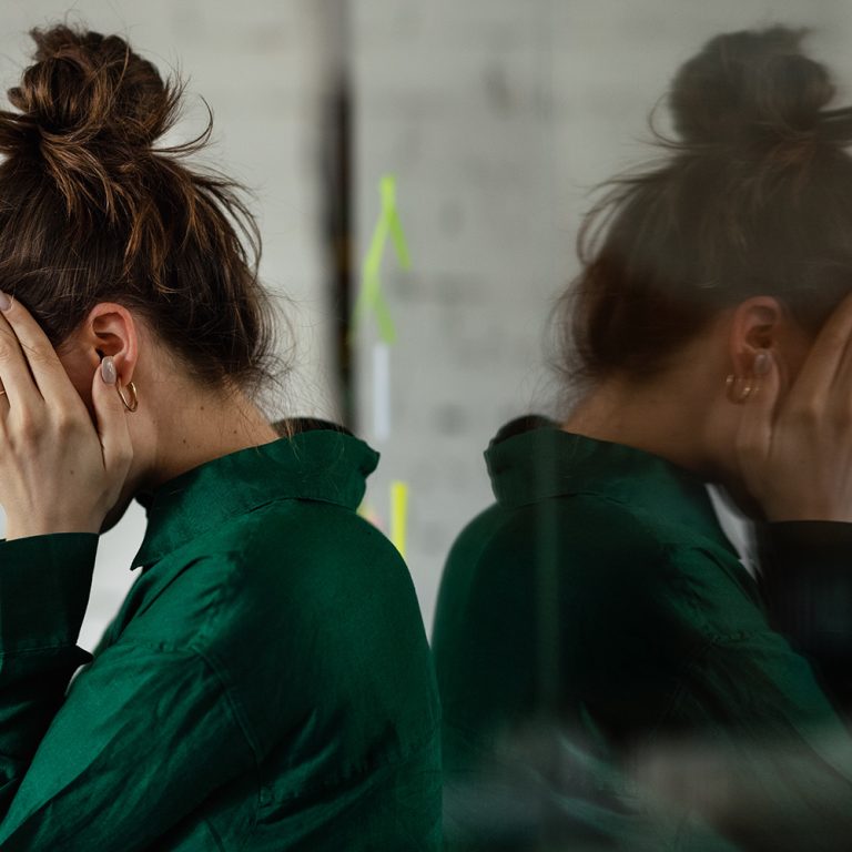 Young sad woman in office, having troubles.