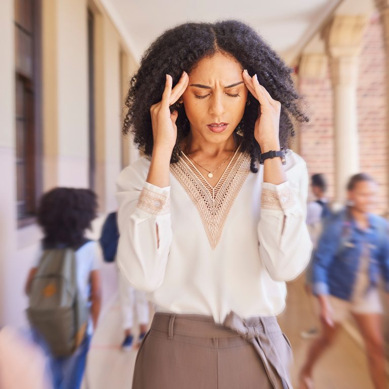 Headache, tired and stress teacher in school with fast children thinking of work stress, education .